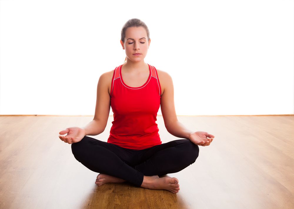 Sitting woman doing breathing exercises.