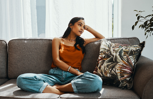 Woman sitting on a couch and being inactive