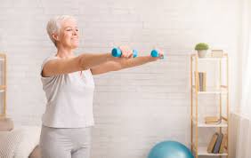Senior woman exercising with dumbbells.