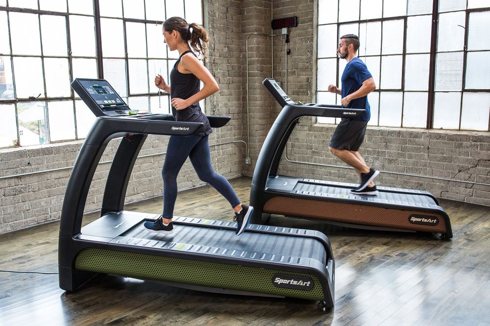 Woman and man exercising on a treadmill.