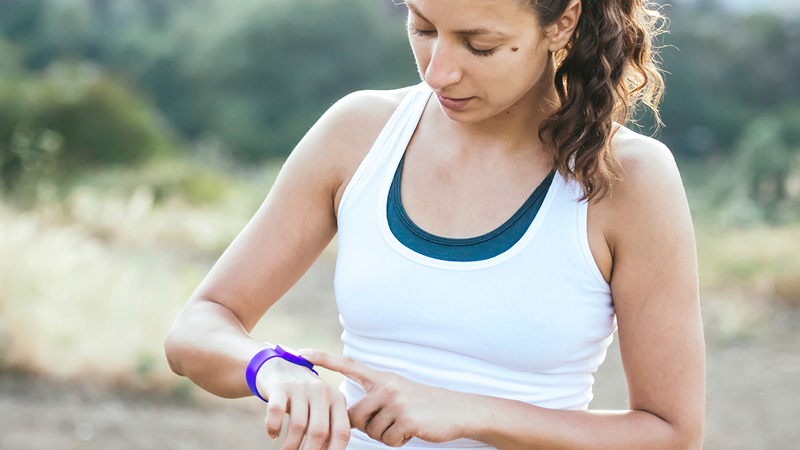 Woman looking at her fitness tracker watch.