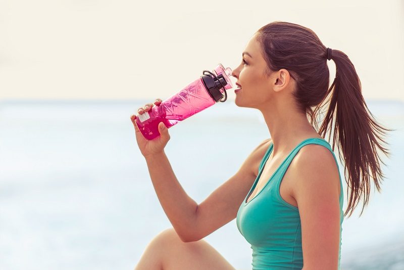 Woman drinking bottled water.