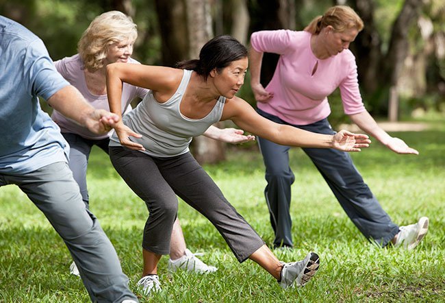 Group practising Tai Chi in the park.