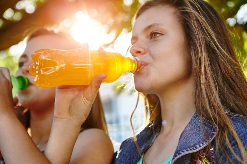 Teen girl drinking soft drink.