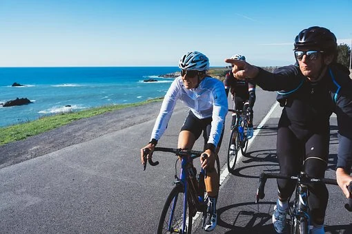 Bicycle riders traveling on the road.