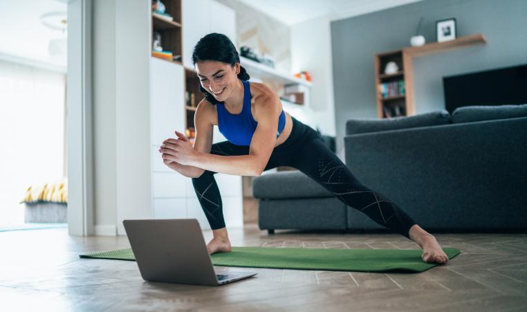 Woman exercising in front of her computer.