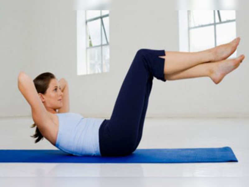 Woman exercising on gym mat.