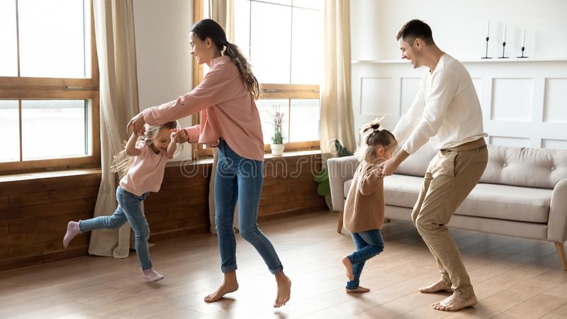 Family exercising together in the living room.