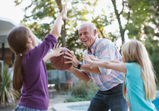 Man playing basketball with the grandkids.