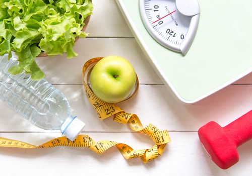 Display of weight scale and foods for a healthy diet.