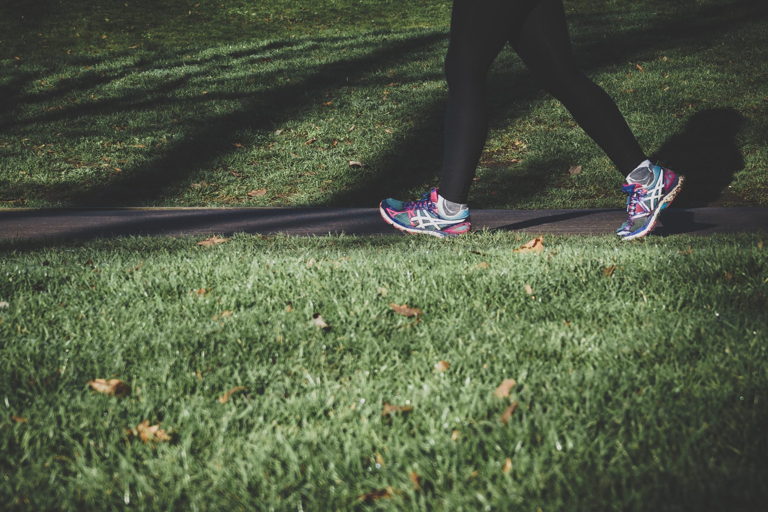 Woman walking and exercising on a trail.