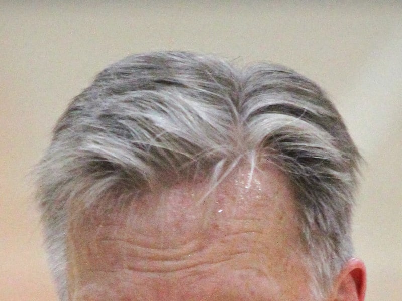 Man displaying his gray hair.