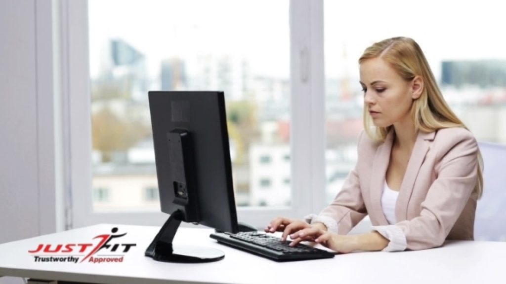 Woman typing on a computer keyboard.