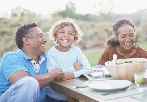 Family sitting at a table eating out.