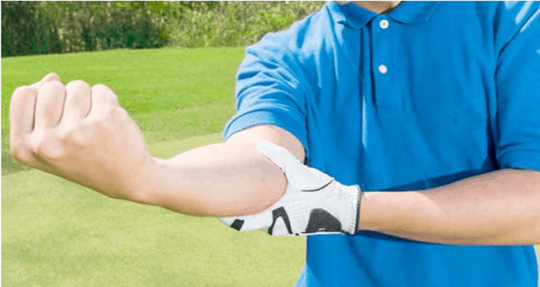 Man holding his elbow after golf.