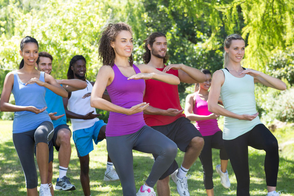 Group of people in a Tai Chi oudoors class.