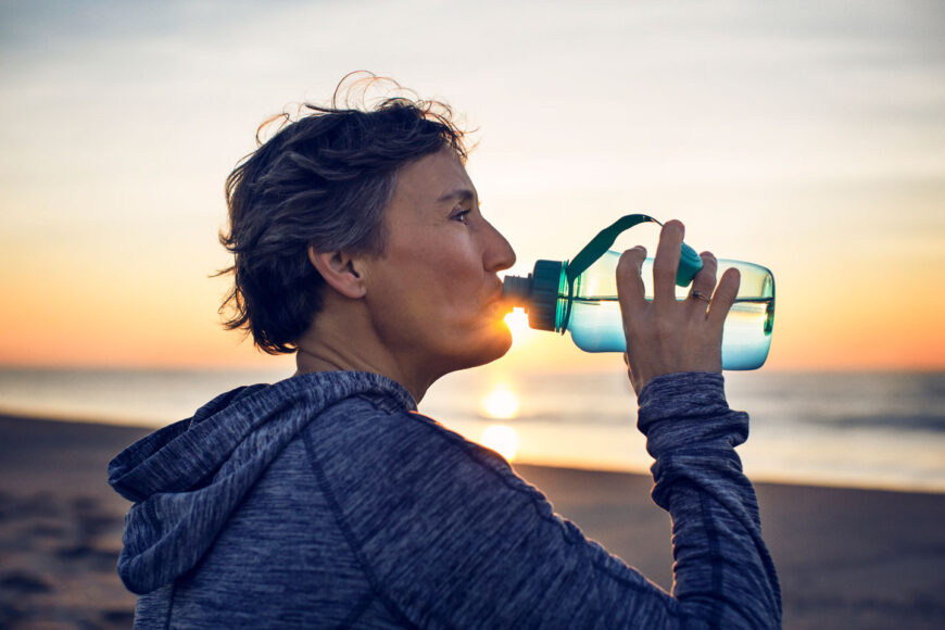 Woman drinking water from a bottle.