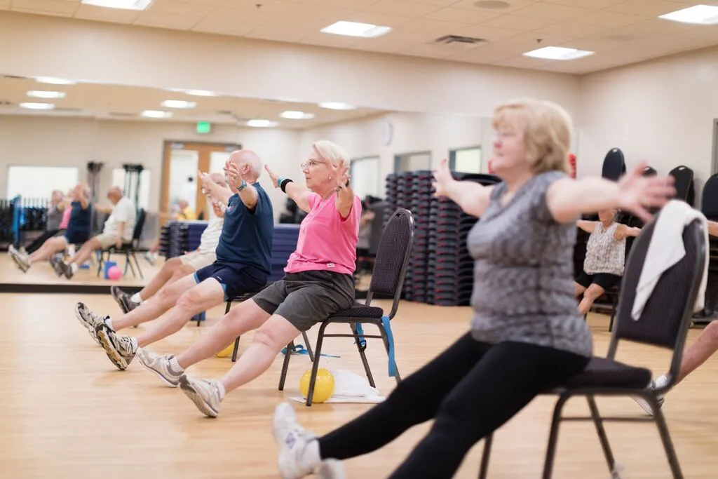 Group of seniors demonstrating seated tai chi