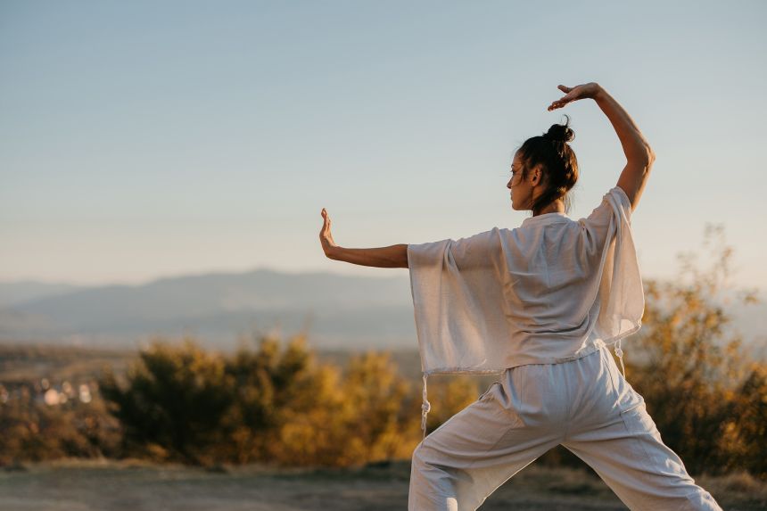 Woman demonstrating Tai Chi to improve sleep.