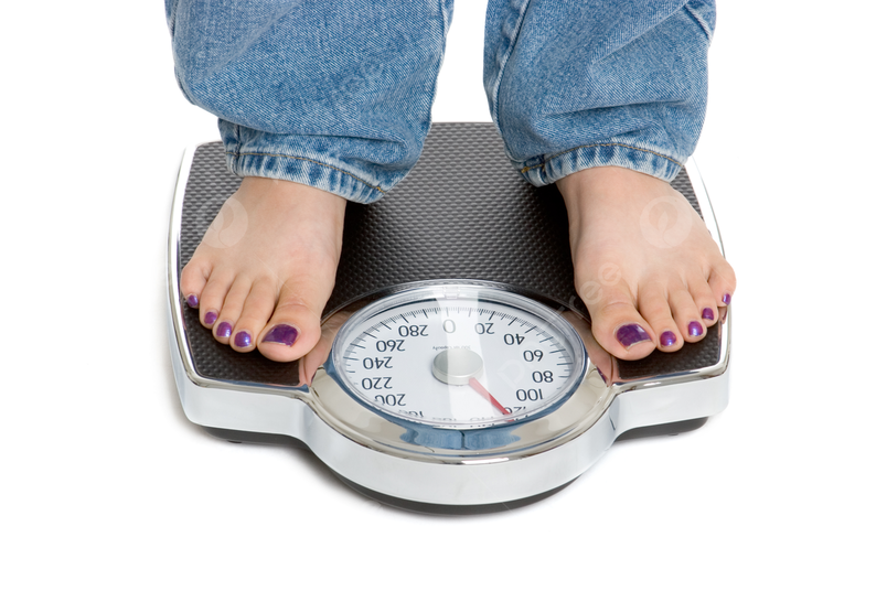 Woman standing on a weight scale